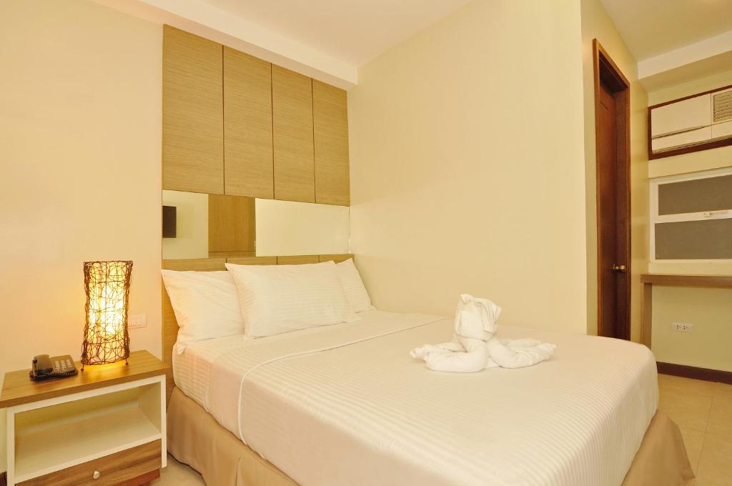 Postel nebo postele na pokoji v ubytování Belian Hotel