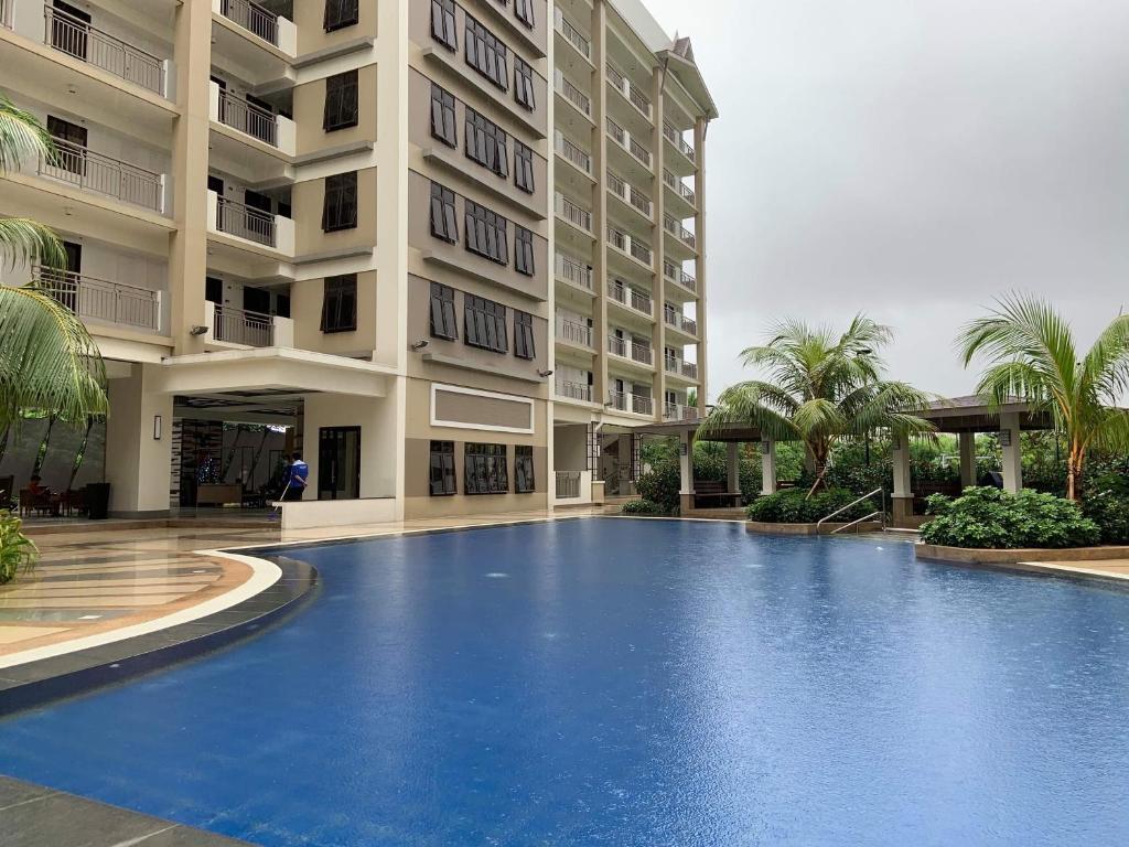 een groot zwembad voor een gebouw bij Estellar Resort Condotel in Manilla