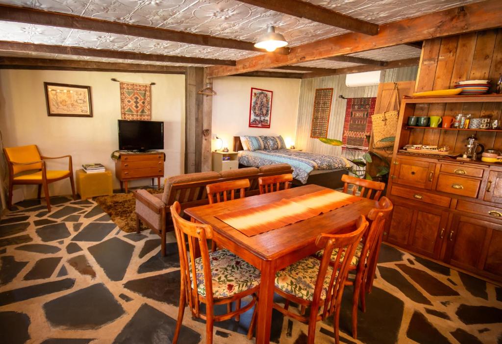 a living room with a wooden table and chairs at Gardenhouse on George in Burra