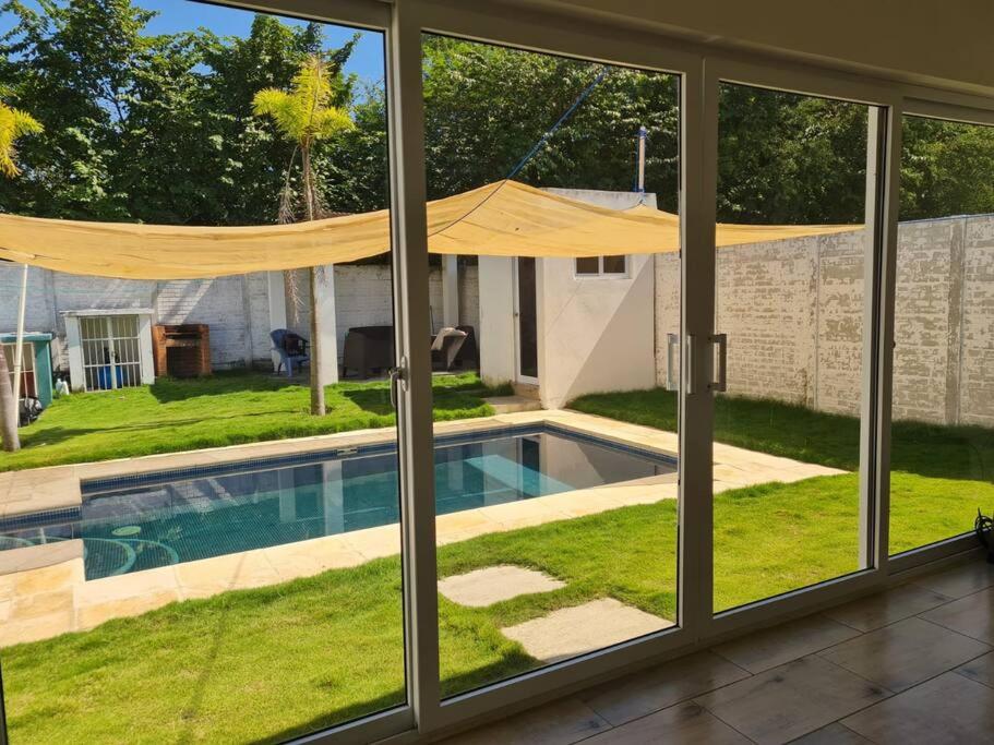 a view of a swimming pool through a window at Casa Mochileros Anonimos in El Guayabo