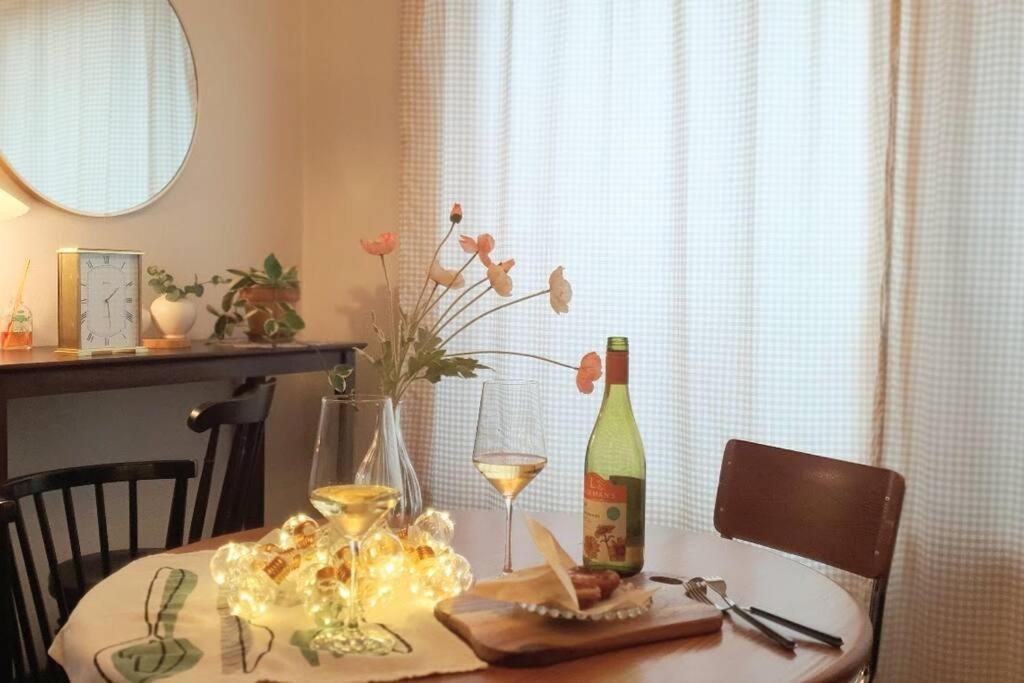 a table with a bottle of wine and a glass at Our moment #EuropeAirbnbmood#freeparking#cafebathroom#simmons#max4 in Daejeon