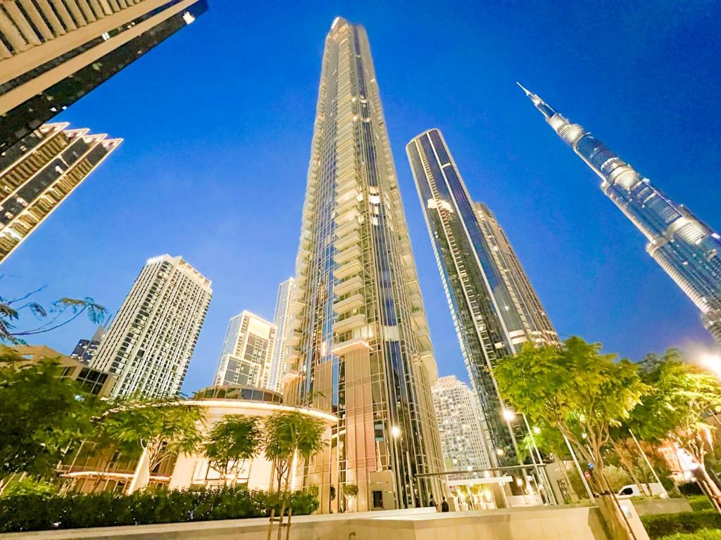a view of a city skyline with skyscrapers at Downtown Luxury - Stunning Burj Khalifa & Sea View - 5 Minutes Walk to Dubai Mall in Dubai