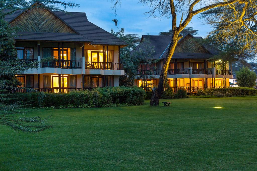 a large house with a tree in front of it at Sawela Lodges in Naivasha