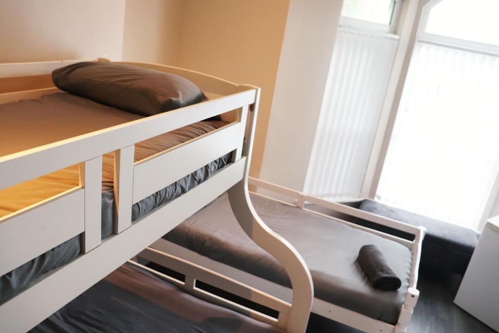 a bunk bed with a brown pillow on top of it at Kop View in Liverpool