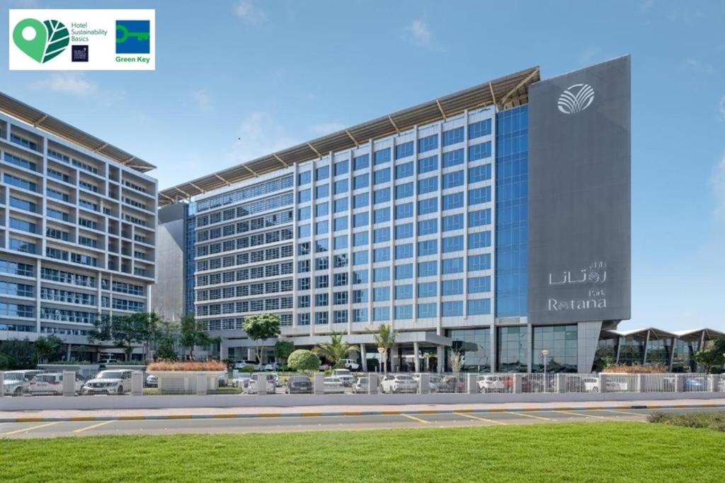 a rendering of a large building with cars parked outside at Park Rotana Abu Dhabi in Abu Dhabi