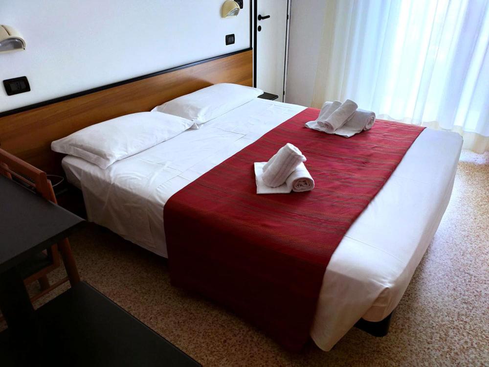 Postel nebo postele na pokoji v ubytování Ben Hur Rimini
