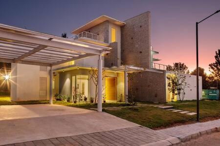 a large house with a large at Golf View Home by JadeCaps 4BHK with Breakfast in Hosūr