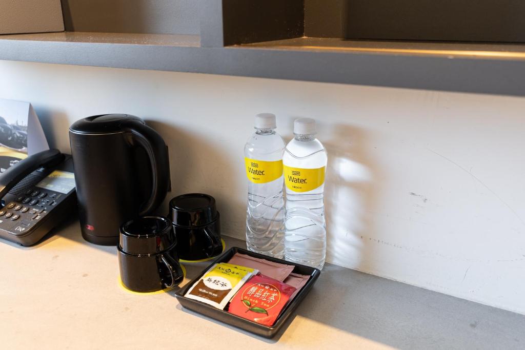 two bottles of water sitting on a kitchen counter at CHECK inn Taichung Liming in Taichung