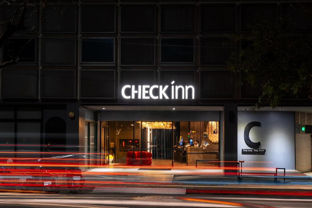 a building with a cheykim sign on it at night at CHECK inn Taichung Liming in Taichung