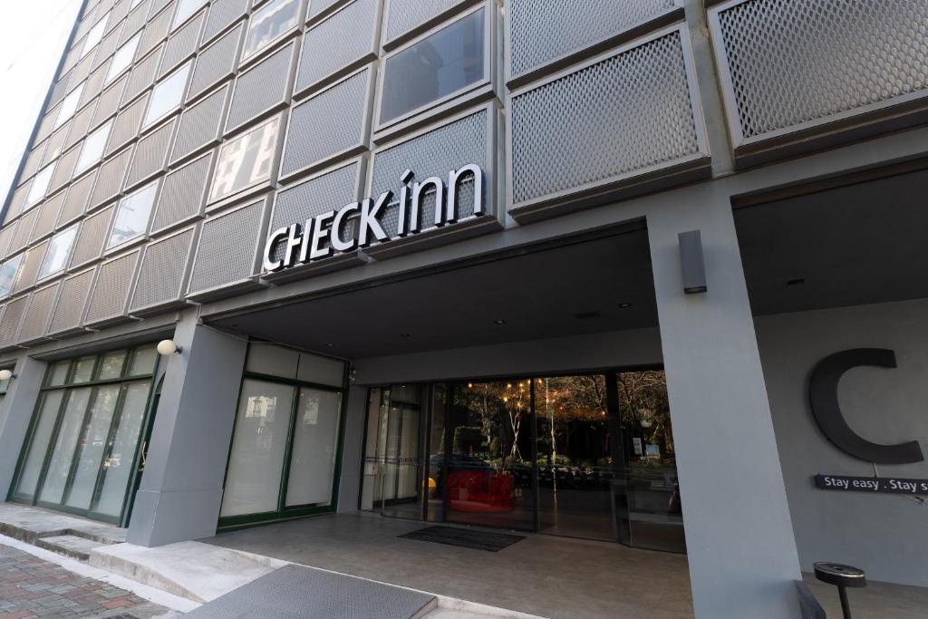 a building with a checkin sign on the side of it at CHECK inn Taichung Liming in Taichung