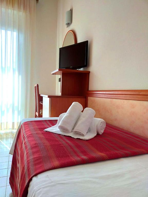 Postel nebo postele na pokoji v ubytování Ben Hur Rimini