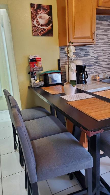 a kitchen with a table with chairs and a counter at Eastwood Escape in Nassau