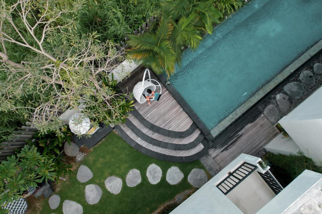an overhead view of a small boat in a garden at D'Green Kuta Managed by ARM Hospitality in Legian