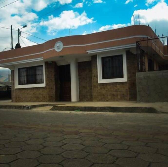 a small brick house with a red roof at Casa Andina Los Ilinizas in Chaupi