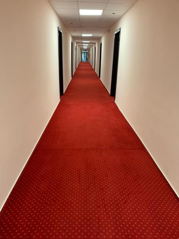 a red carpet corridor with a long red carpet at Hotel Hermes in Eforie Nord