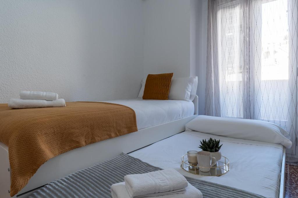 A bed or beds in a room at tuGuest Gran Via 42