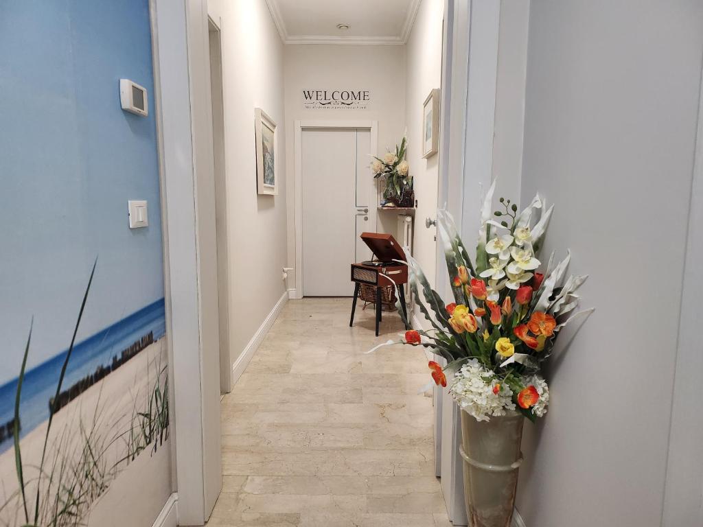 a hallway with a vase of flowers on the wall at Delia in Sanremo