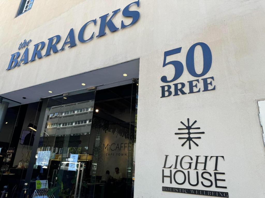 a store with a sign for a light house at Bree Street Apartment - Explore, Eat, Experience Cape Town in Cape Town