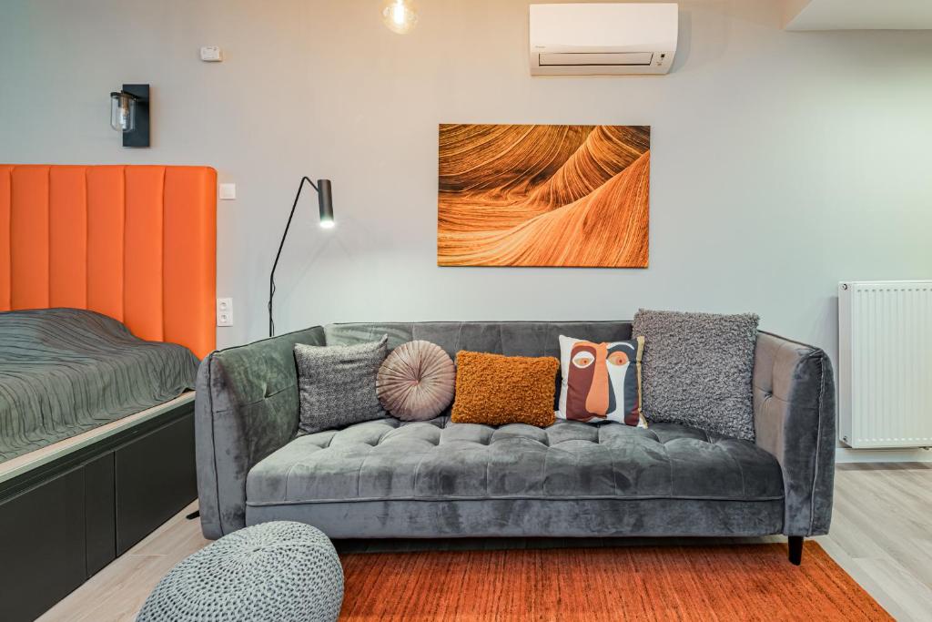 a living room with a couch and a bed at Luxury Tropical Apartment at Budapest in Budapest