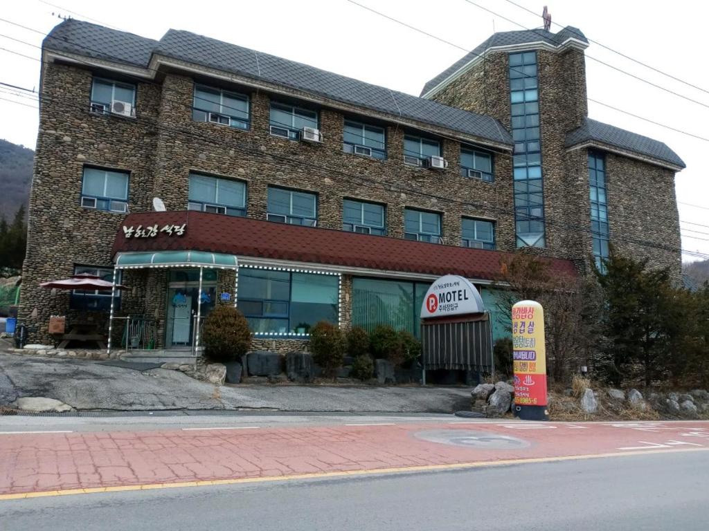 a large brick building on the side of a street at Namhangang Park Motel in Chungju