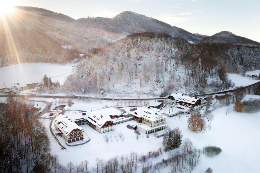 an aerial view of a resort in the snow at Arabella Jagdhof Resort am Fuschlsee, a Tribute Portfolio Hotel in Hof bei Salzburg