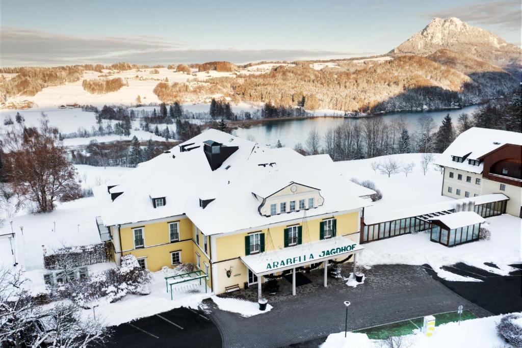 an aerial view of a hotel in the snow at Arabella Jagdhof Resort am Fuschlsee, a Tribute Portfolio Hotel in Hof bei Salzburg