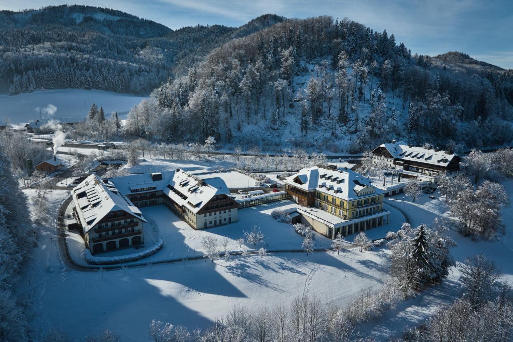 an aerial view of a resort in the snow at Arabella Jagdhof Resort am Fuschlsee, a Tribute Portfolio Hotel in Hof bei Salzburg