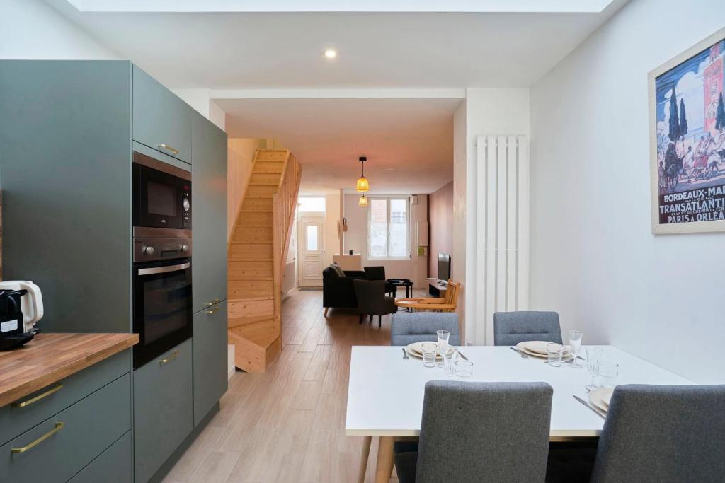 a kitchen and a dining room with a table and chairs at House in Lille near Euratech private terrace. in Lille