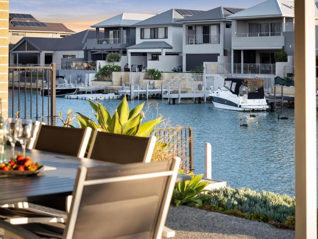 a view of a marina with a boat in the water at Mariner's Cove Luxury Canal Home in Mandurah