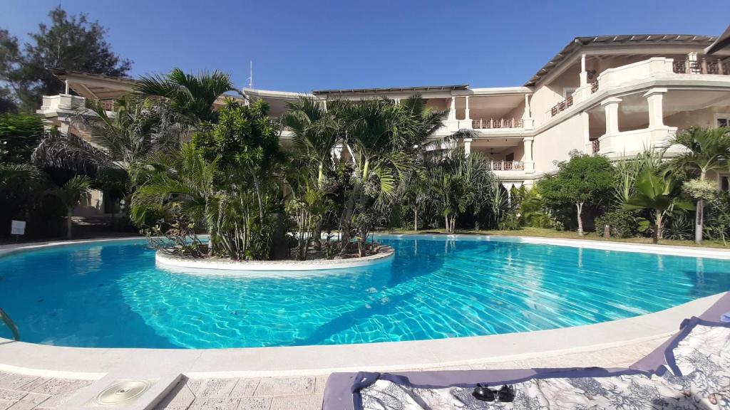 a large swimming pool in front of a building at GIORGIA HOUSE WATAMU BEACH in Watamu