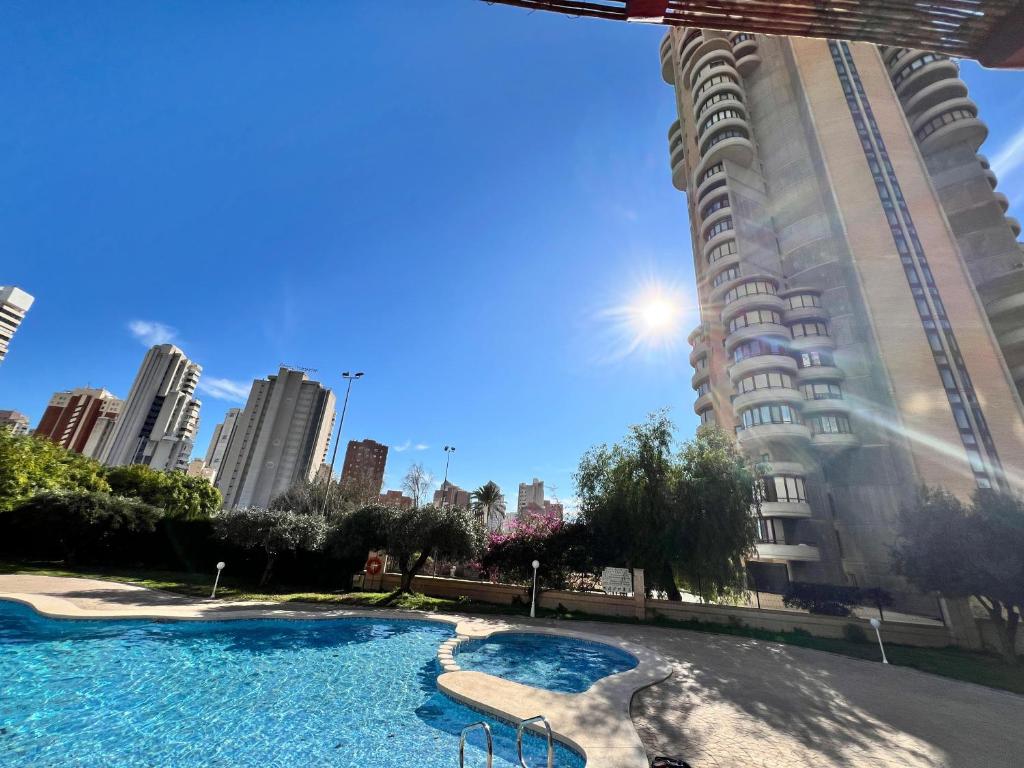 a large swimming pool in front of a tall building at Neptuno View 22 in Benidorm