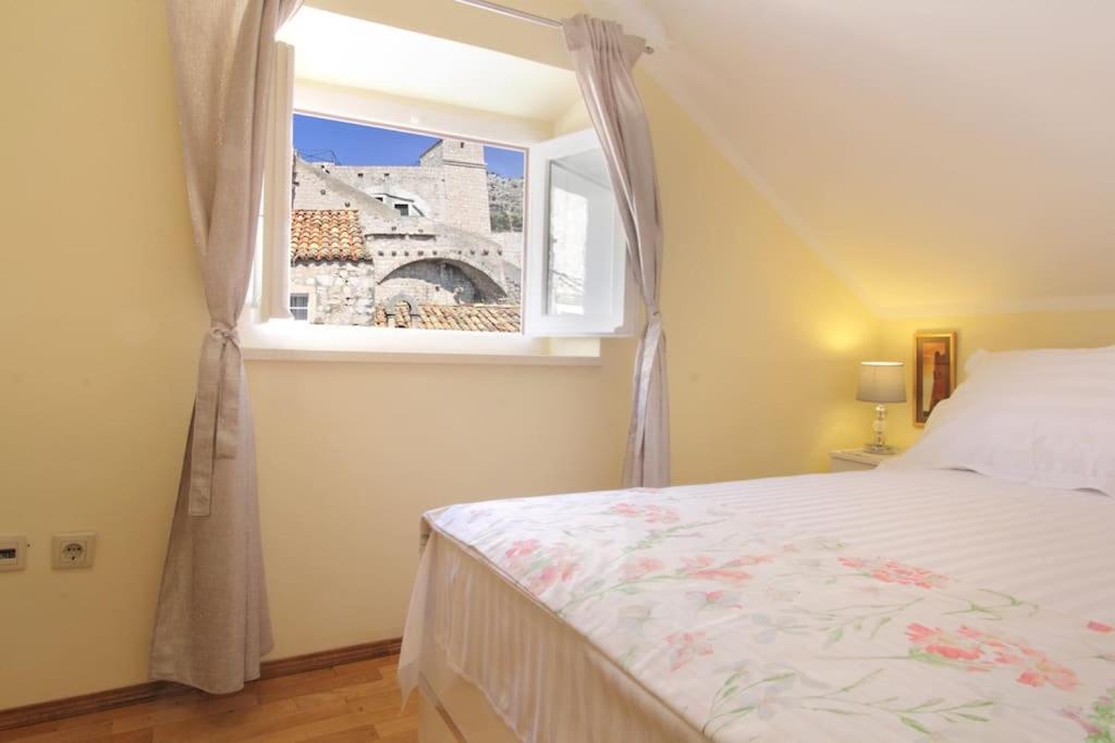 a bedroom with a bed and a window at Apartment Kovac Old Town 2 in Dubrovnik