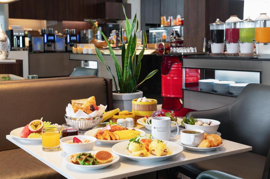 A generously styled breakfast spread served at a table beside a buffet station.