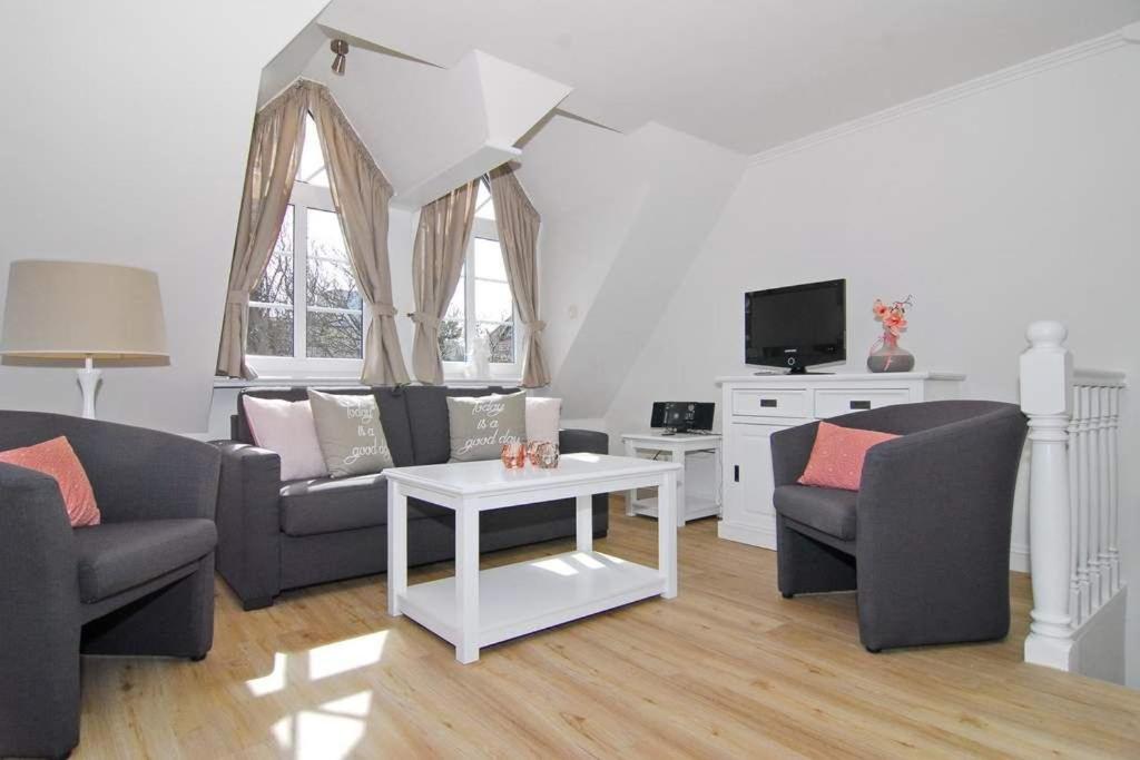 uma sala de estar com dois sofás e uma mesa em Olympia Haus 1, Whg 3 em Westerland