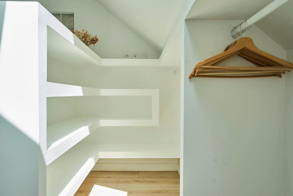 a white staircase in a room with white walls at Loft en duplex atypique 4ch + parking in Tourcoing