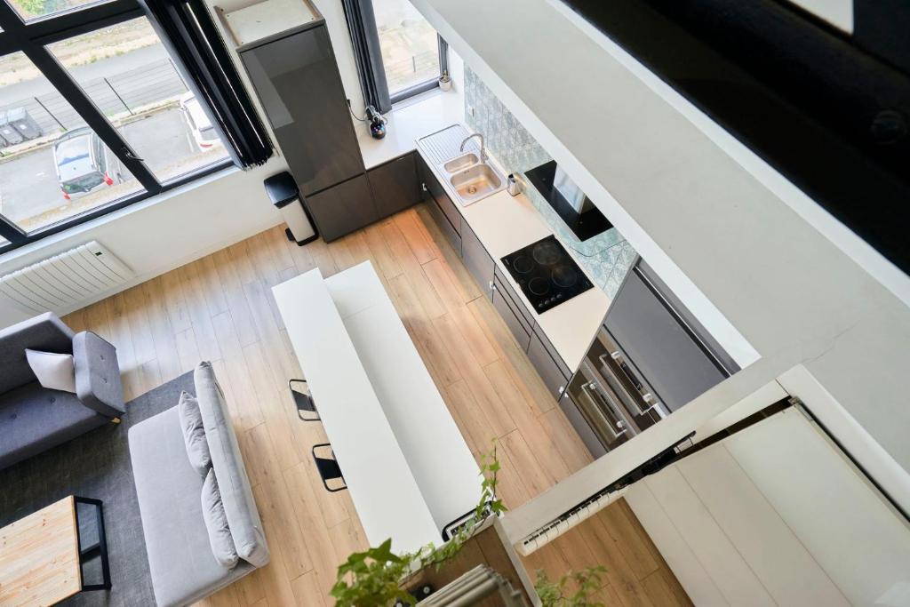 an overhead view of a living room in a house at Loft en duplex atypique 4ch + parking in Tourcoing