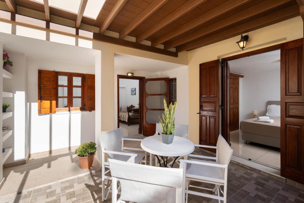 un salon avec une table et des chaises dans l'établissement Plethora Homes, à Kamari