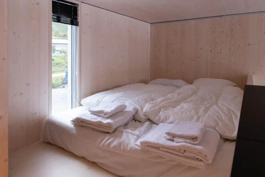 a white bed with towels on it in a room at Oceanview Mini-House - Stunning Views in Ramberg