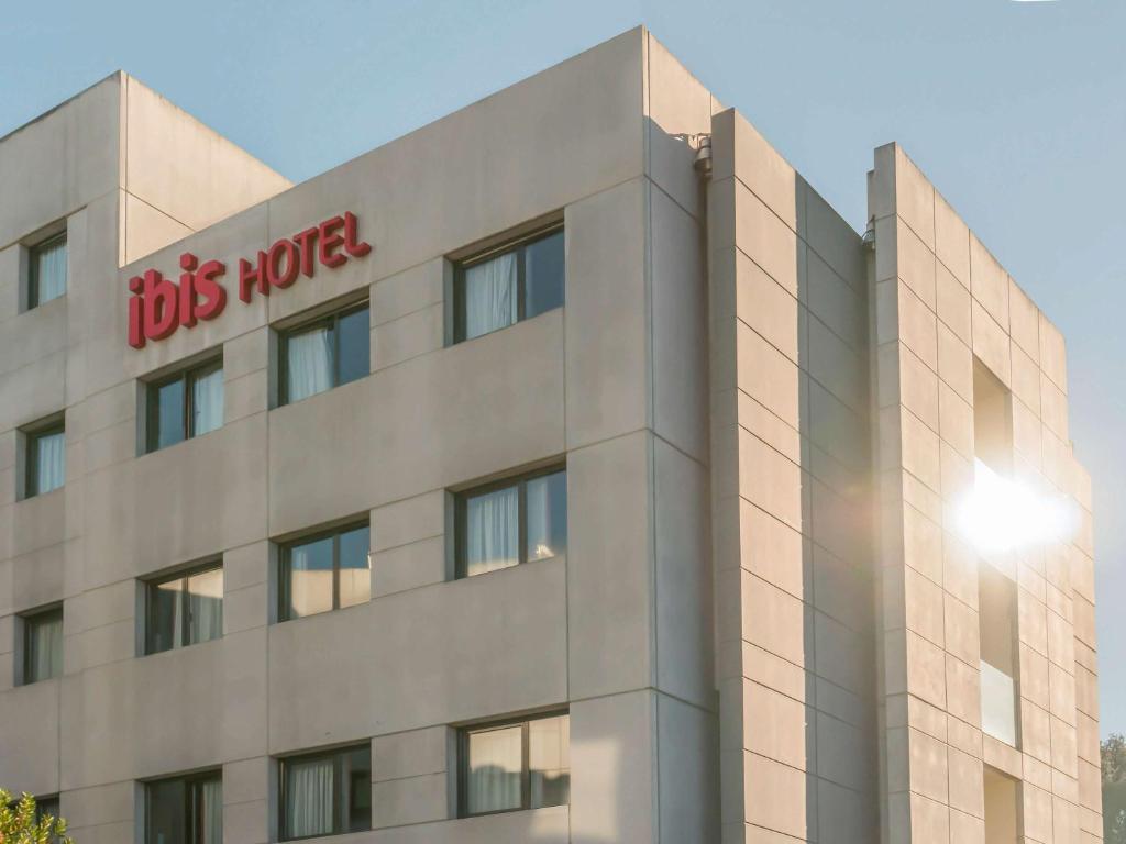 a building with a big mortar sign on it at Ibis Girona in Girona