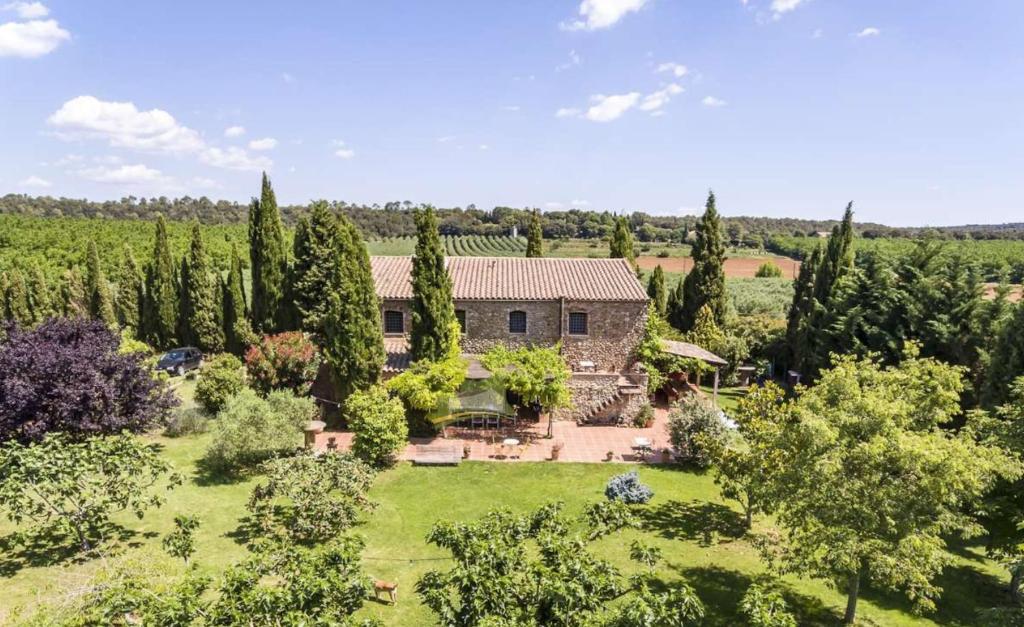 an aerial view of a house with a garden at Private country house surrounded by olive trees in Crespiá