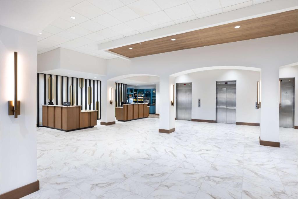 a lobby of a hotel with a large marble floor at DoubleTree by Hilton Houston Medical Center Hotel & Suites in Houston