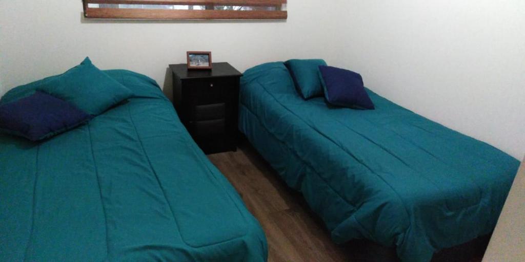 two beds sitting next to each other in a bedroom at vip huertos familiares in San Pedro de la Paz