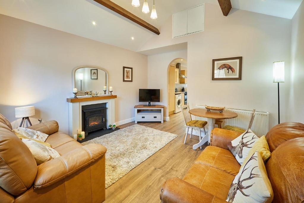 a living room with a couch and a fireplace at Host & Stay - Gas Light Cottage in Ripon
