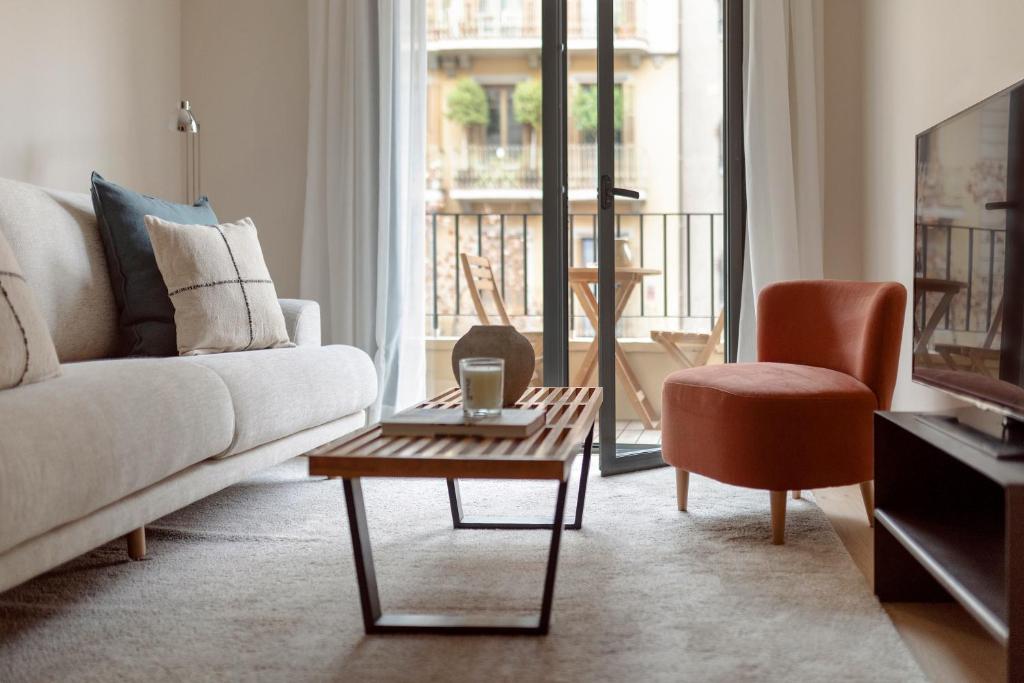 a living room with a couch and a coffee table at C211 Barcelona Apartments in Barcelona