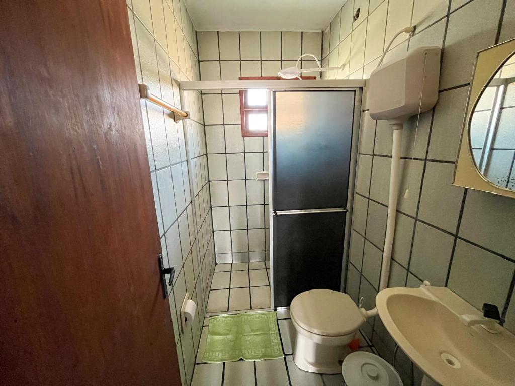 een kleine badkamer met toilet en wastafel bij Kitnet no Melhor Ponto de Bombinhas in Bombinhas