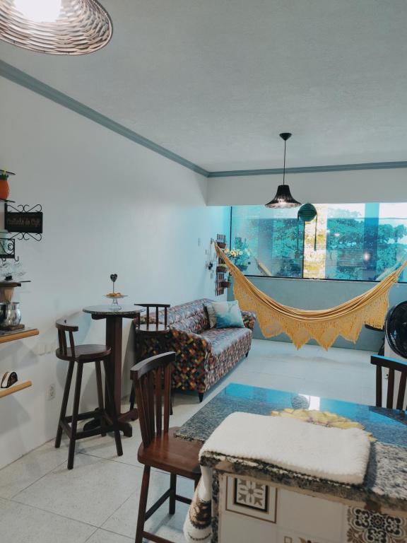 a living room with a couch and a table at Alu Azul 1 in Barra de São Miguel