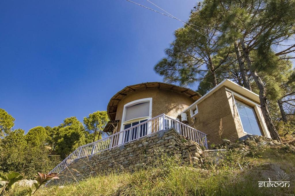 a house on top of a hill with stairs at Sukoon BluSalzz Escapade, Bhatrojkhan, Near Ranikhet, Uttarakhand in Tota Ām