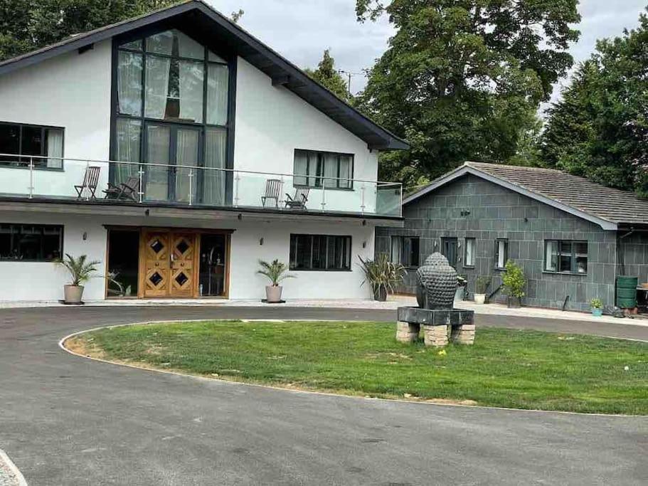 a house with a statue in front of it at Hendrix’s cottage in Lincoln