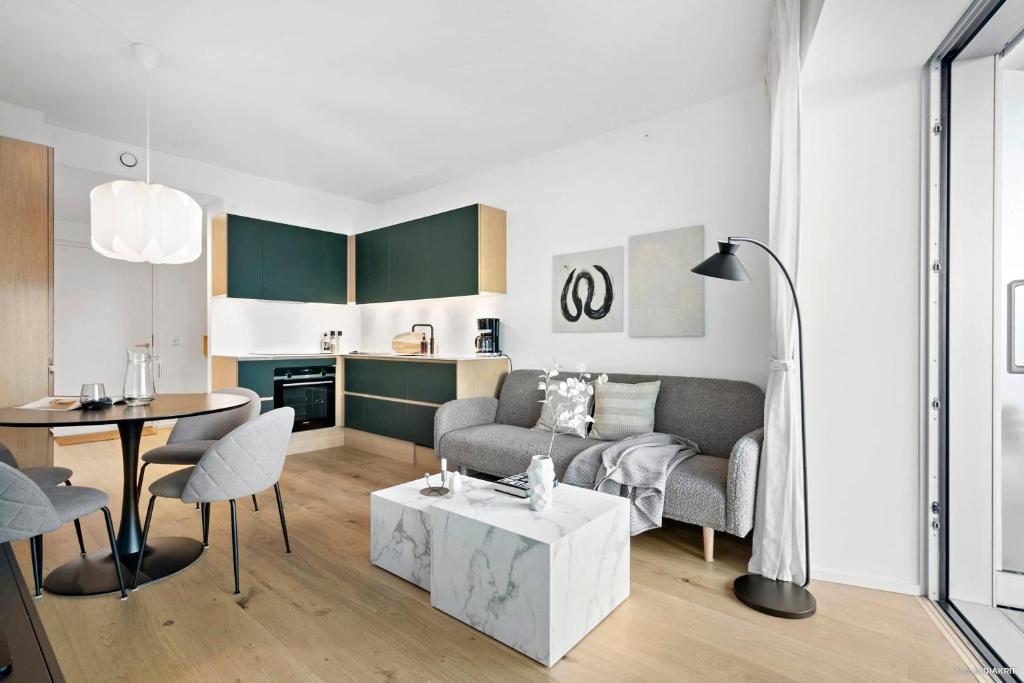 a living room with a couch and a table at Best view in Denmark from 40th floor in Aarhus