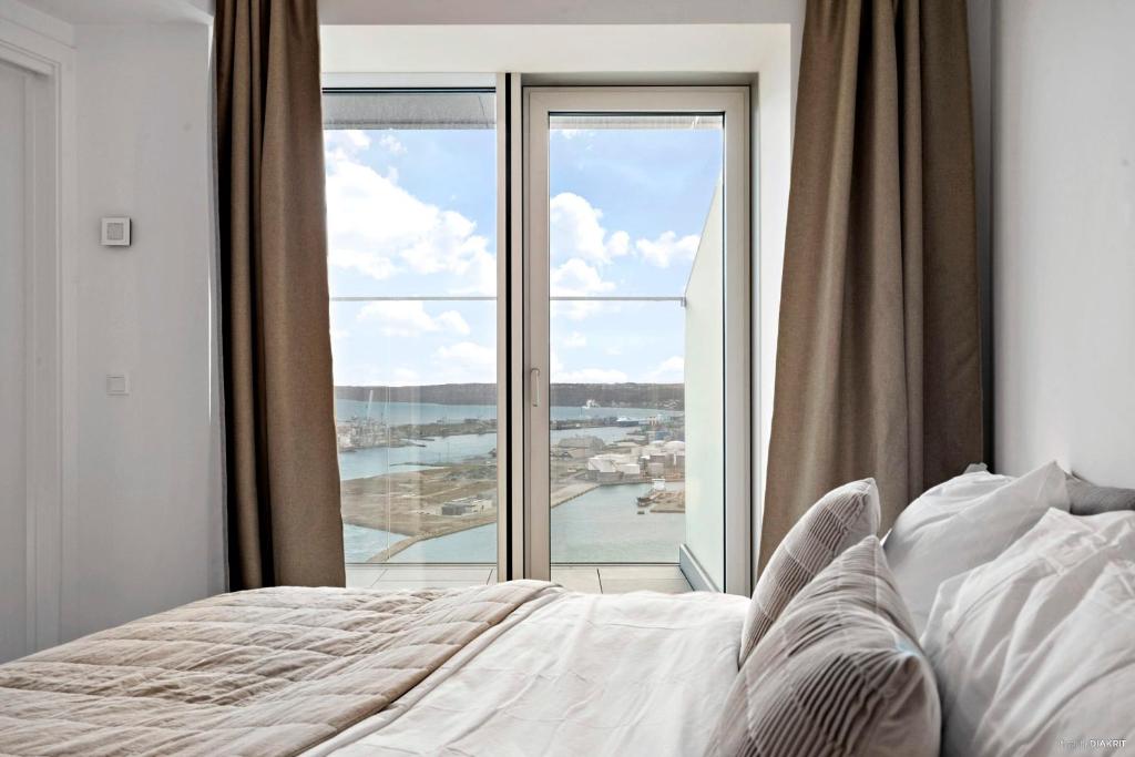 a bedroom with a bed and a large window at Best view in Denmark from 40th floor in Aarhus